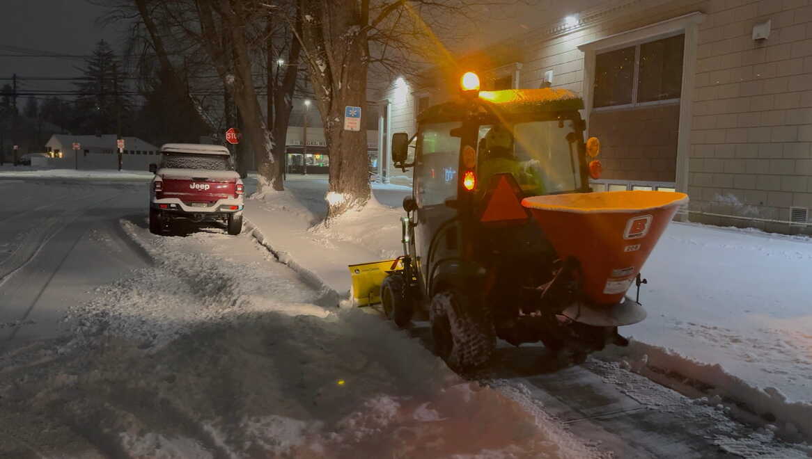 Picture of a reinigen lawns sidewalk machine clearing snow from a commercial hospital